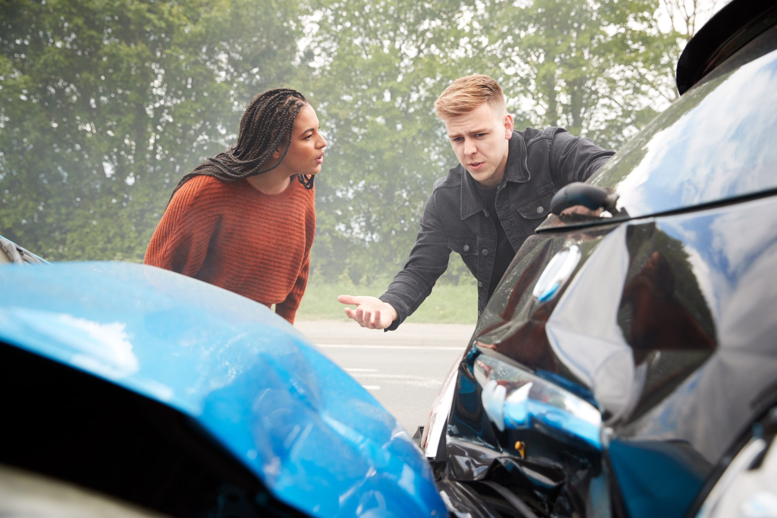 Drivers discussing an insurance claim after an accident